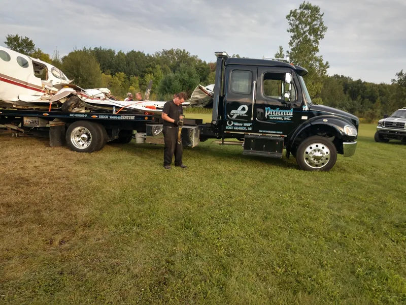 Preferred flatbed carrying a damaged vehicle